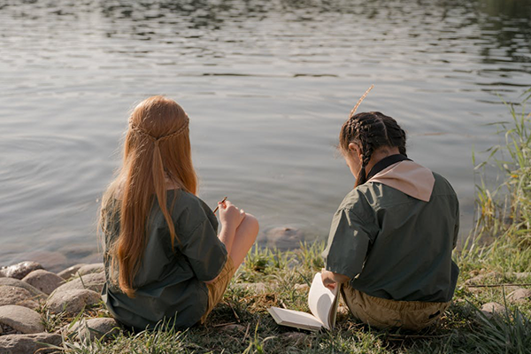 a picture of two scouts infront of a body of water