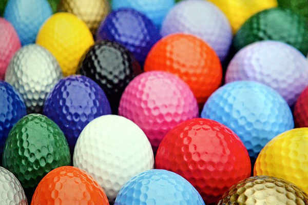 a pile of golfballs, all different colors